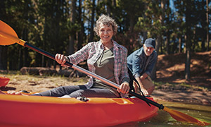 Retired couple paddling kayaks