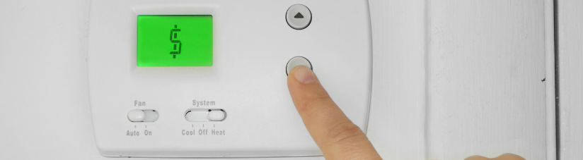 finger pushing button on thermostat