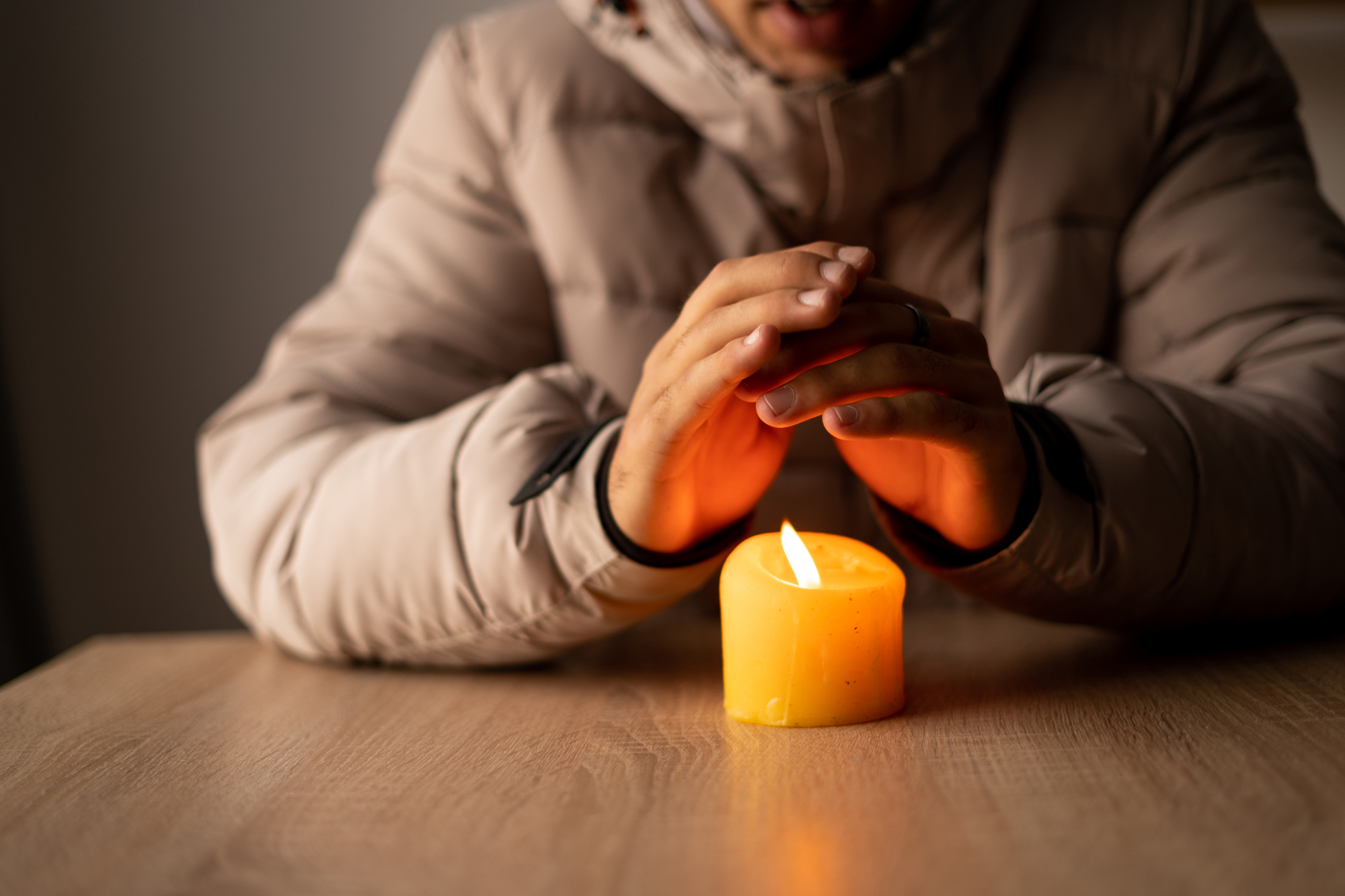 Warming hands over candle
