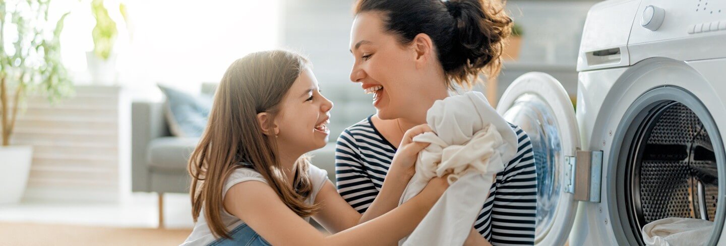 Mother and daughter doing laundry together