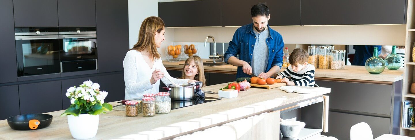 Family preparing meal in a modern kitchen