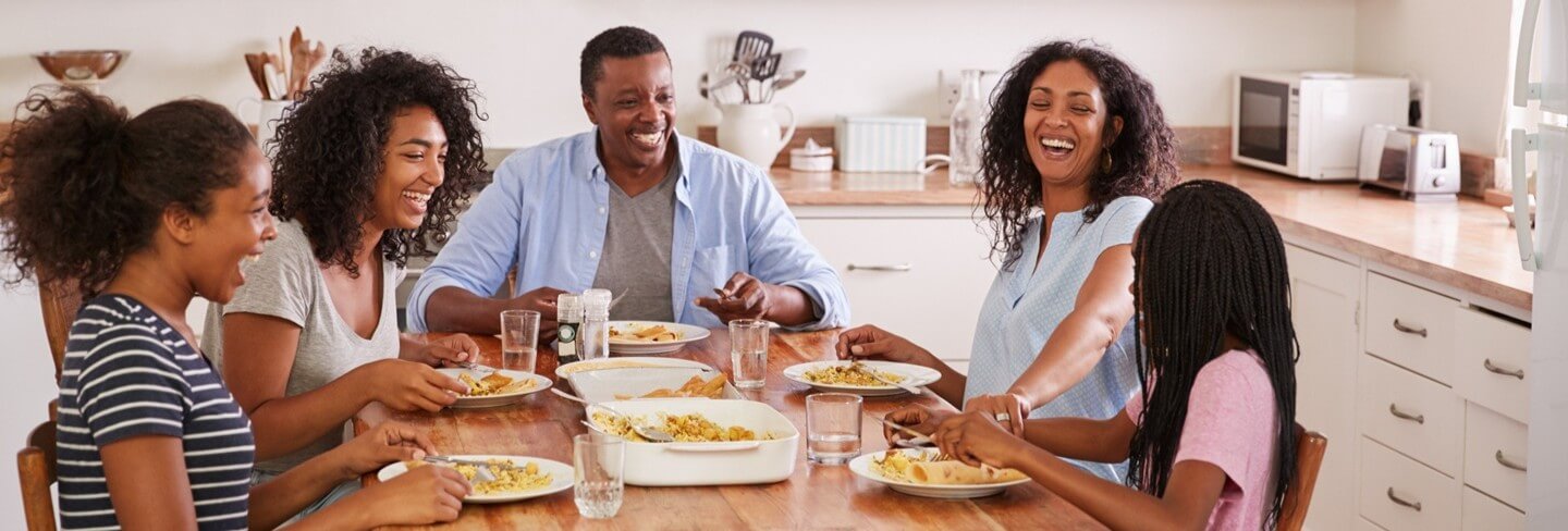 Family eating meal together in the kitchen