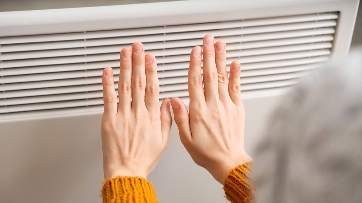 Warming hands over a space heater